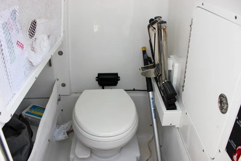 Slide: The Image of 2022 Sea Hunt Gamefish 27 boat interior with toilet and storage compartments. - 26