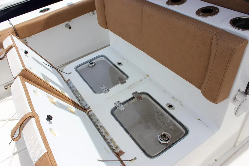 Slide: The Image of 2022 Sea Hunt Gamefish 27 Forward Seating with open storage compartments and cushioned seating. - 28