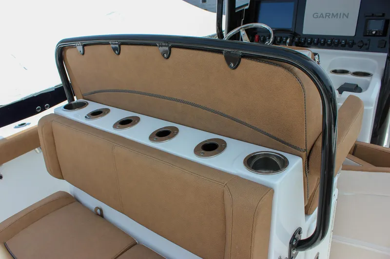 Slide: The Image of 2022 Sea Hunt Gamefish 27 boat seating with integrated cup holders and Garmin electronics. - 29