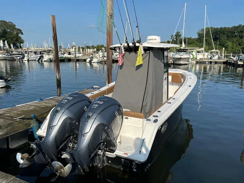 Slide: The Image of 2022 Sea Hunt Gamefish 27 boat docked with twin engines and fishing rods. - 3