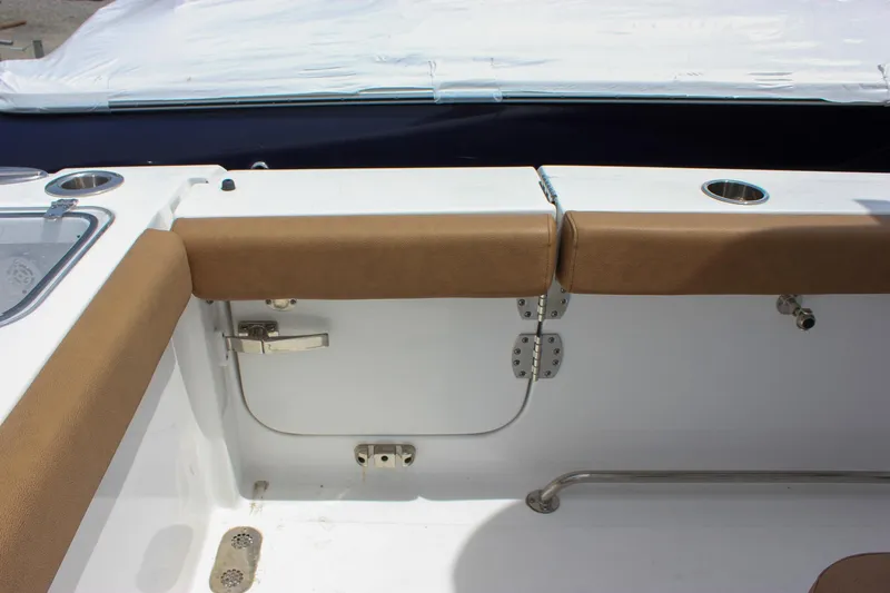 Slide: The Image of 2022 Sea Hunt Gamefish 27 Forward Seating interior with tan cushions and stainless steel fixtures. - 33