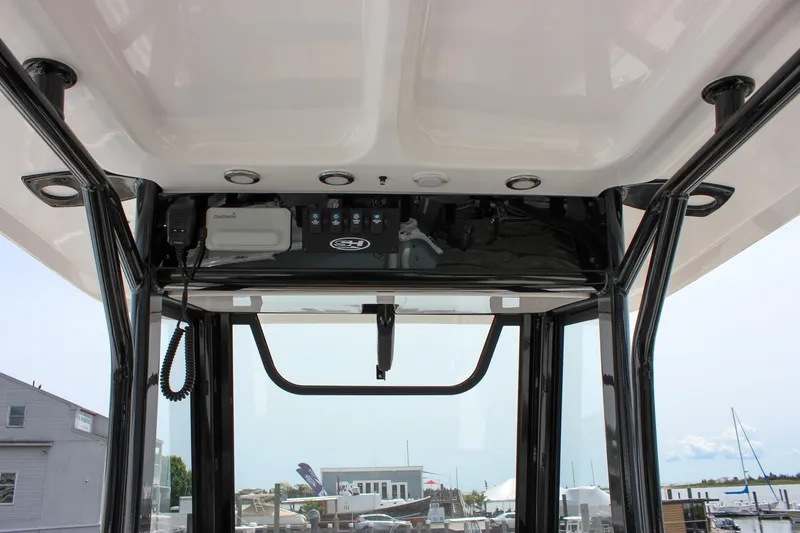 Slide: The Image of 2022 Sea Hunt Gamefish 27 Forward Seating boat console with electronics and storage. - 35