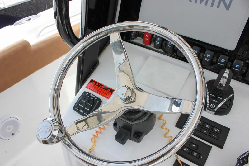 Slide: The Image of Steering wheel of 2022 Sea Hunt Gamefish 27 Forward Seating boat with control panel. - 37