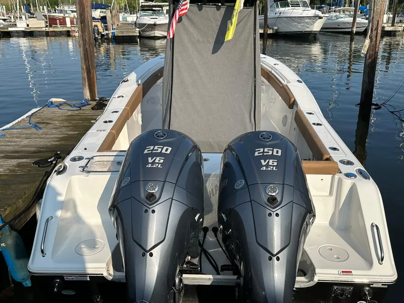 Slide: The Image of 2022 Sea Hunt Gamefish 27 with twin 250 V6 engines docked at marina. - 38