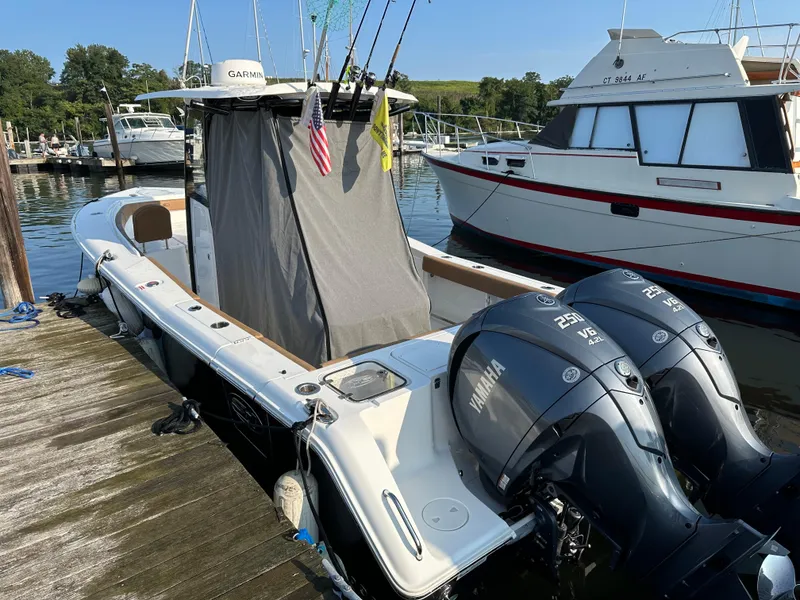 Slide: The Image of 2022 Sea Hunt Gamefish 27 boat docked with twin Yamaha engines. - 39