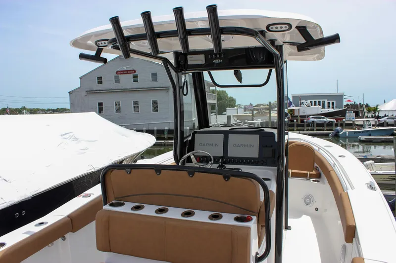 Slide: The Image of 2022 Sea Hunt Gamefish 27 boat with forward seating, docked at a marina. - 4