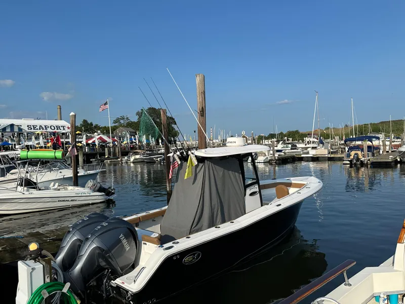 Slide: The Image of 2022 Sea Hunt Gamefish 27 boat docked at marina with clear blue sky. - 40