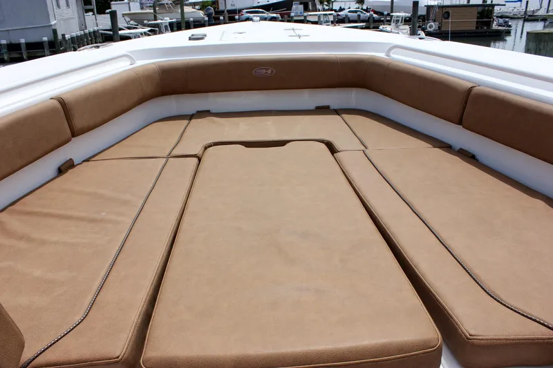 Slide: The Image of 2022 Sea Hunt Gamefish 27 Forward Seating with tan cushions, offering spacious comfort. - 7