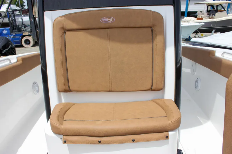 Slide: The Image of 2022 Sea Hunt Gamefish 27 Forward Seating with tan cushions and sleek design. - 8