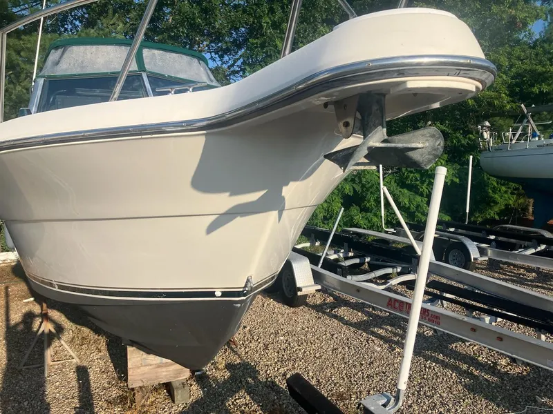 Slide: The Image of 1998 Pursuit 2860 Denali boat on trailer, parked outdoors. - 4