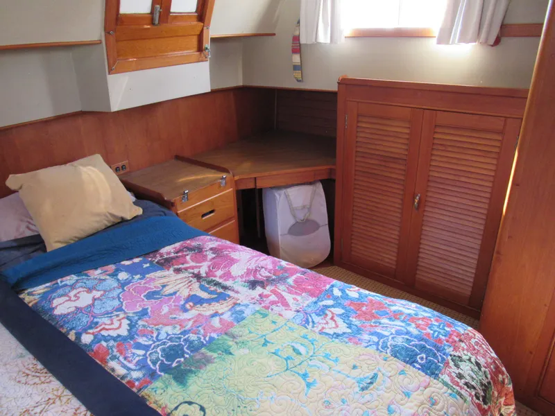 Slide: The Image of Cozy cabin interior of 1985 Grand Banks 42 Classic with colorful bedding and wooden furnishings. - 10