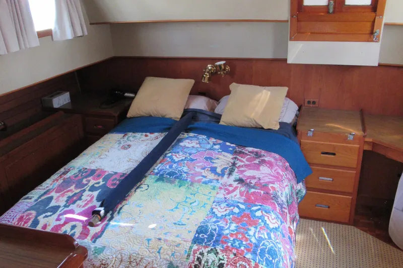Slide: The Image of Cozy bedroom in 1985 Grand Banks 42 Classic yacht with colorful quilt and wooden furnishings. - 12