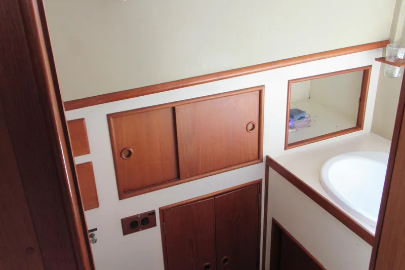 Slide: The Image of 1985 Grand Banks 42 Classic yacht interior with wooden cabinets and sink. - 14