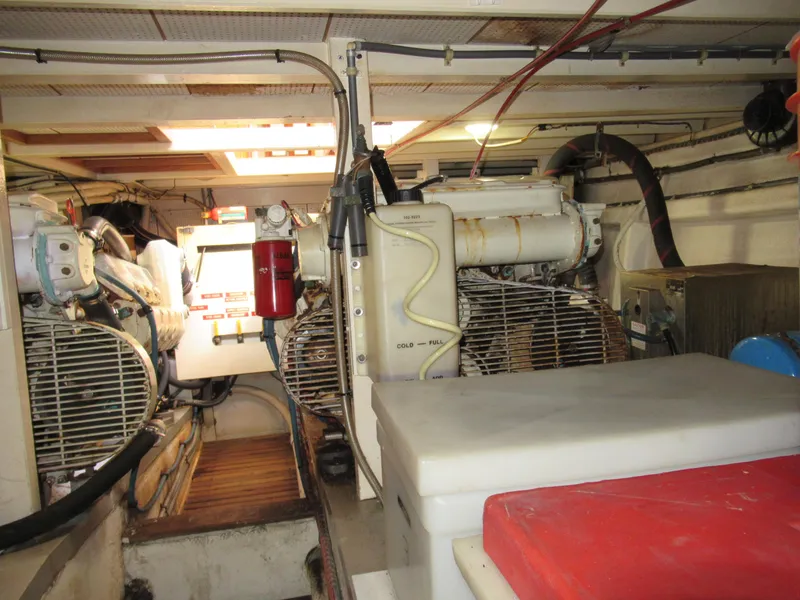 Slide: The Image of Engine room of 1985 Grand Banks 42 Classic yacht, featuring mechanical equipment and storage. - 16