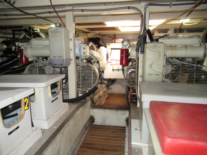 Slide: The Image of Engine room of a 1985 Grand Banks 42 Classic yacht, featuring dual engines and equipment. - 17