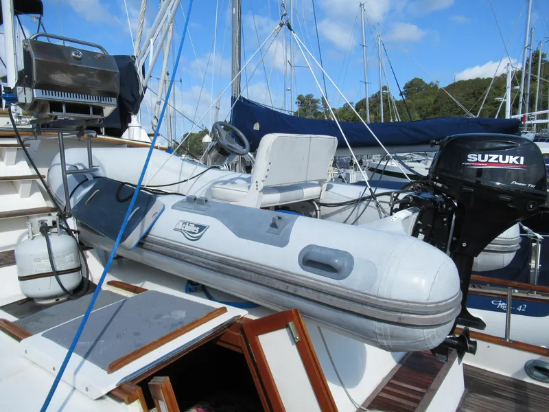 Slide: The Image of 1985 Grand Banks 42 Classic yacht with inflatable dinghy and Suzuki outboard motor. - 25
