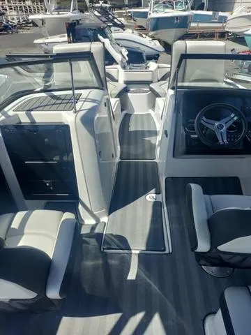 Slide: The Image of 2019 Yamaha Boats 242 Limited S E-Series interior with sleek seating and modern dashboard. - 11