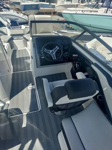 Slide: The Image of 2019 Yamaha Boats 242 Limited S E-Series cockpit with steering wheel and seating. - 12