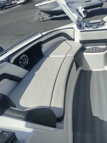 Slide: The Image of 2019 Yamaha Boats 242 Limited S E-Series interior seating area with sleek design. - 18