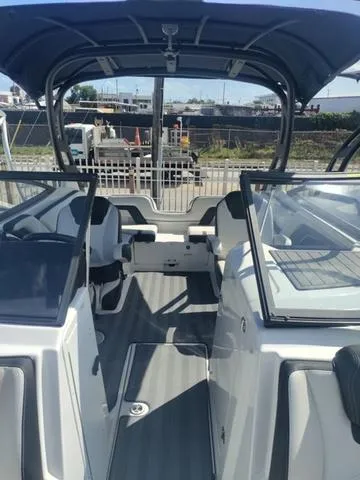 Slide: The Image of 2019 Yamaha Boats 242 Limited S E-Series interior with seating and dashboard. - 20