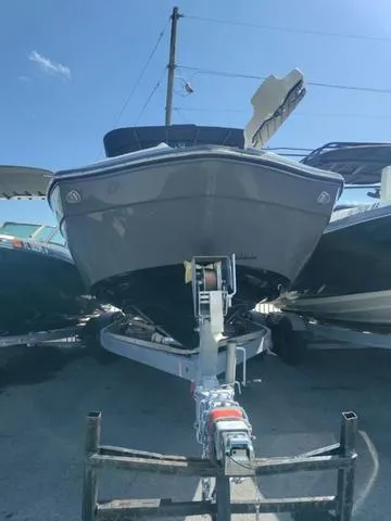 Slide: The Image of 2019 Yamaha Boats 242 Limited S E-Series on trailer, front view under clear sky. - 5