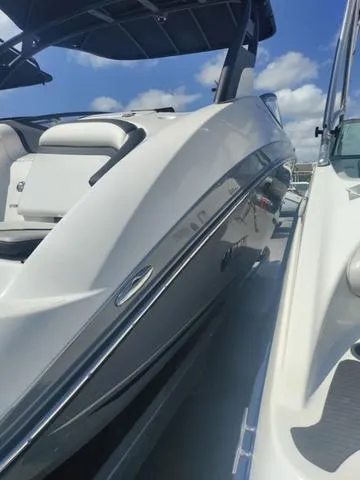 Slide: The Image of 2019 Yamaha Boats 242 Limited S E-Series, sleek design under blue sky. - 7