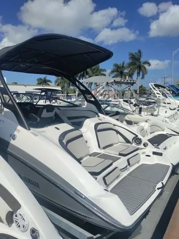 Slide: The Image of 2019 Yamaha Boats 242 Limited S E-Series, sleek design, docked under blue sky. - 9