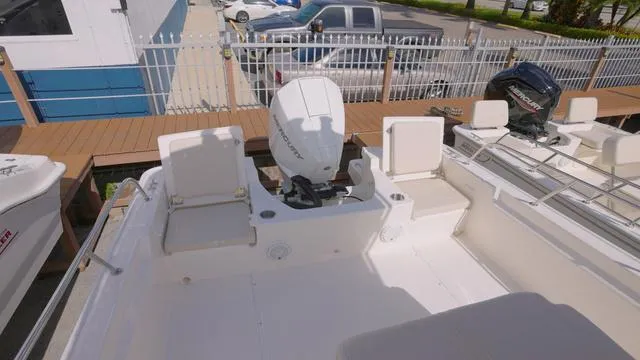 Slide: The Image of 2024 Boston Whaler 210 Montauk boat interior with outboard motor and seating. - 10