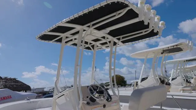 Slide: The Image of 2024 Boston Whaler 210 Montauk boat with T-top under blue sky. - 12