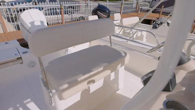 Slide: The Image of 2024 Boston Whaler 210 Montauk boat interior with seating and controls. - 14