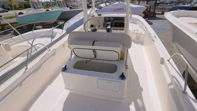 Slide: The Image of 2024 Boston Whaler 210 Montauk boat interior with open storage compartment. - 15
