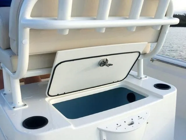 Slide: The Image of 2024 Boston Whaler 210 Montauk boat storage compartment with open lid. - 16