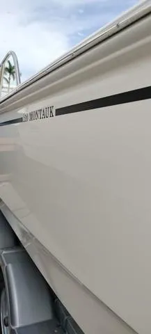 Slide: The Image of 2024 Boston Whaler 210 Montauk boat side view on trailer. - 22
