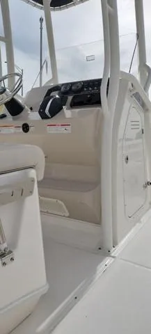 Slide: The Image of 2024 Boston Whaler 210 Montauk boat interior with steering console and seating. - 24