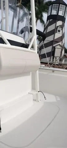 Slide: The Image of 2024 Boston Whaler 210 Montauk boat interior with lighthouse in background. - 27