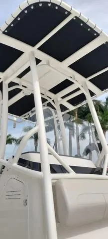 Slide: The Image of 2024 Boston Whaler 210 Montauk boat with T-top canopy and sleek design. - 28