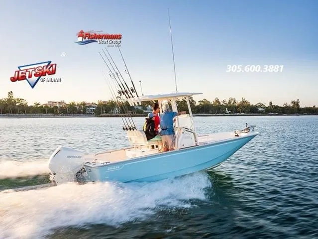 Slide: The Image of 2024 Boston Whaler 210 Montauk cruising on water, featuring fishing rods and Mercury engine. - 31