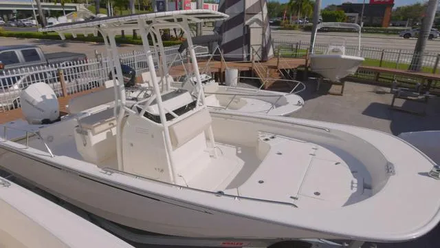 Slide: The Image of 2024 Boston Whaler 210 Montauk boat displayed at a dealership. - 4