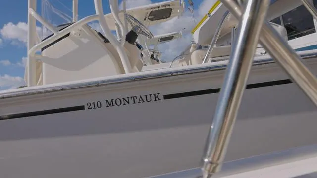 Slide: The Image of 2024 Boston Whaler 210 Montauk boat, close-up view with clear sky background. - 8