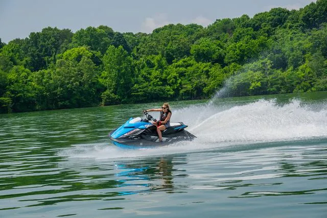 Slide: The Image of 2024 Yamaha Waverunner GP HO™ with Audio speeding on a lake, surrounded by lush greenery. - 30