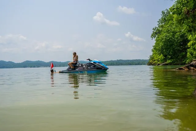 Slide: The Image of 2024 Yamaha Waverunner GP HO™ with Audio on a serene lake, surrounded by lush greenery. - 33
