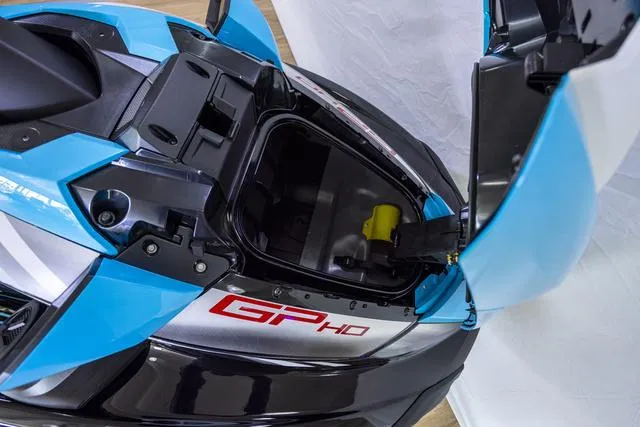 Slide: The Image of 2024 Yamaha Waverunner GP HO with Audio, open storage compartment, blue and black design. - 45