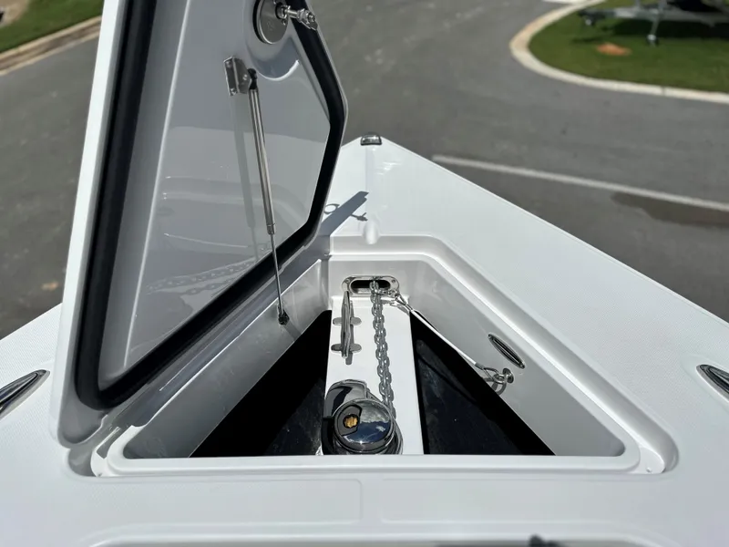 Slide: The Image of Open anchor compartment on 2025 Jupiter 32 boat, showcasing chain and winch. - 10