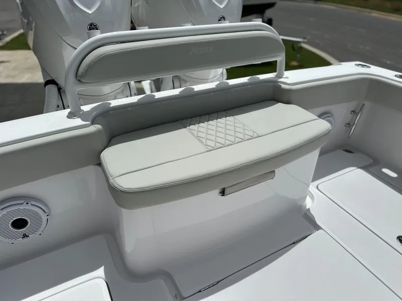 Slide: The Image of 2025 Jupiter 32 boat seating area with cushioned bench and storage compartment. - 12