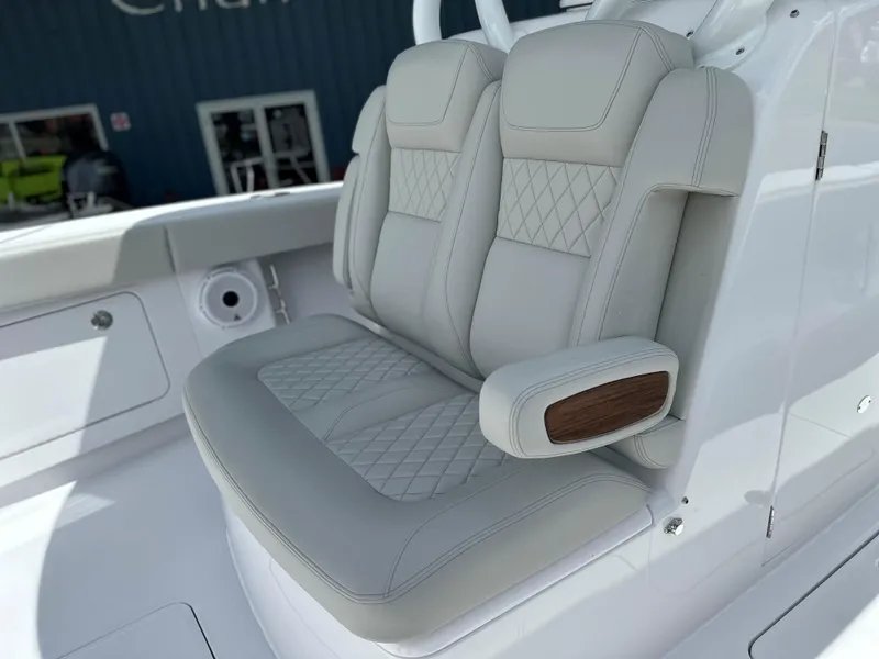 Slide: The Image of Luxurious seating on 2025 Jupiter 32 boat with elegant stitching and armrest. - 16