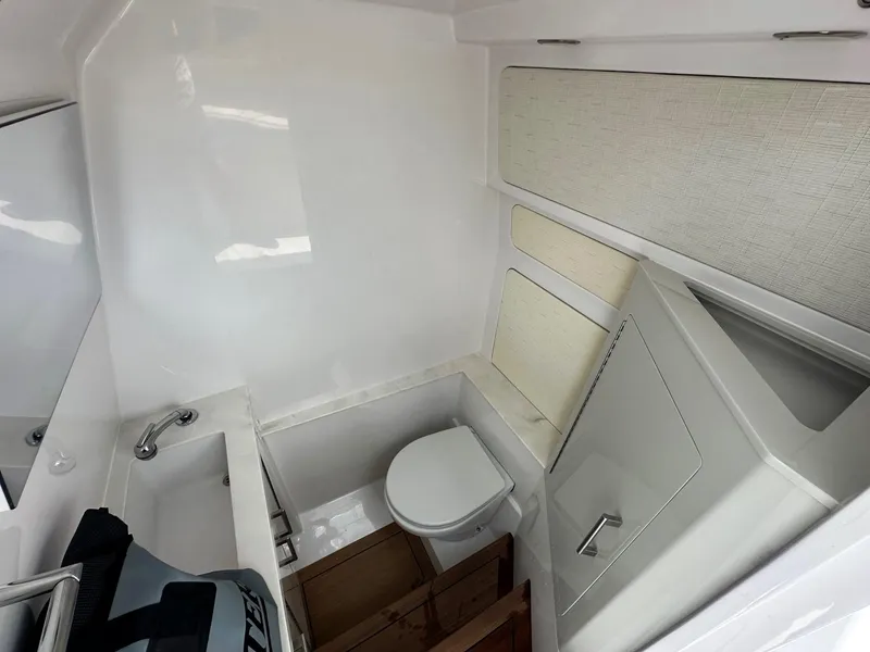 Slide: The Image of Compact bathroom in 2025 Jupiter 32 boat with sink and toilet. - 20