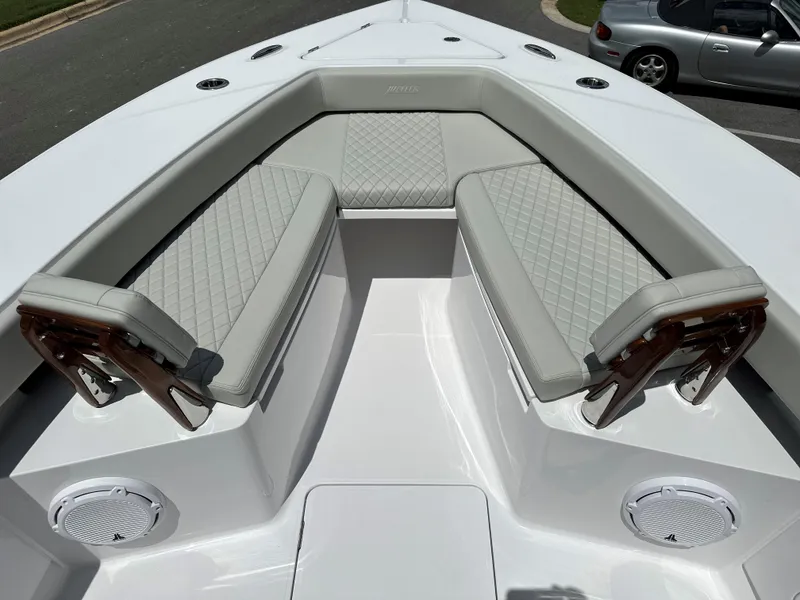 Slide: The Image of 2025 Jupiter 32 boat with cushioned seating and sleek design. - 23