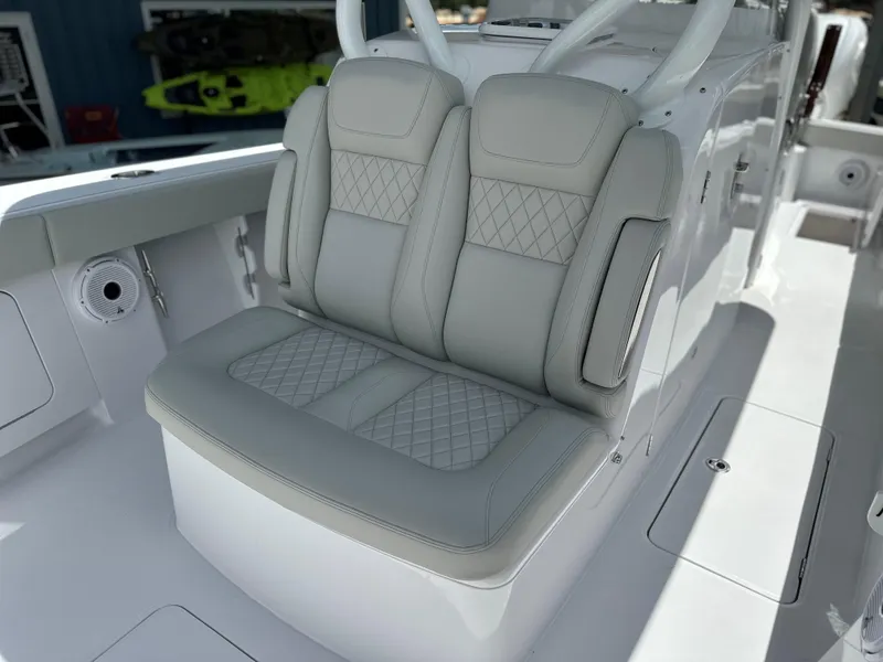 Slide: The Image of Luxury seating on 2025 Jupiter 32 boat with diamond-stitched upholstery. - 26