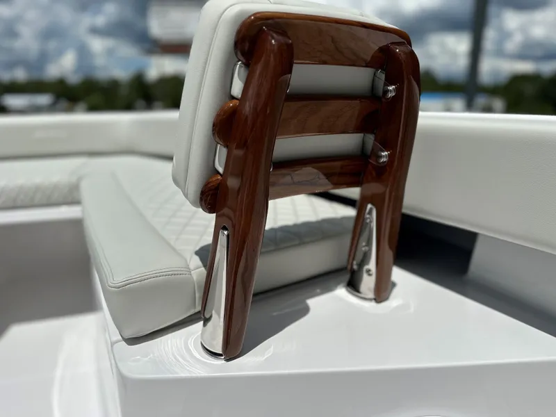 Slide: The Image of Luxurious seating on 2025 Jupiter 32 boat with elegant wood accents. - 31