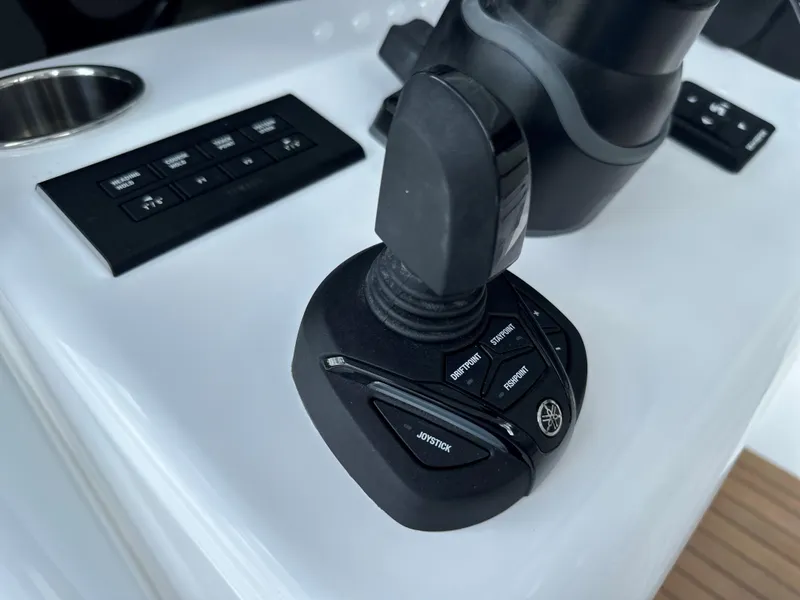 Slide: The Image of Joystick control on 2025 Jupiter 32 boat dashboard with buttons. - 33